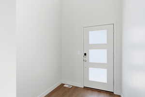 Entryway featuring wood finished floors and baseboards
