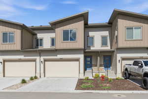 Craftsman-style home featuring a garage, driveway, and board and batten siding