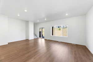 Unfurnished room featuring dark wood finished floors and recessed lighting
