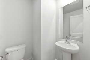 Bathroom featuring toilet and baseboards