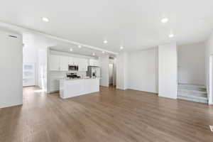 Unfurnished living room featuring light wood-style floors and recessed lighting