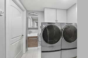 Laundry area with an additional shower and sink.