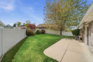 Fenced backyard featuring a patio
