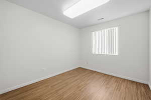 Spare room with wood finished floors and baseboards