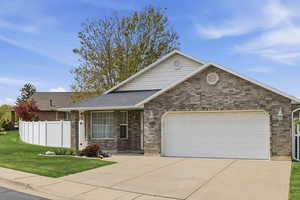 Single story home featuring concrete driveway, an attached garage, brick siding, and roof with shingles