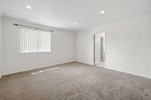 Spare room with ornamental molding, light carpet, and recessed lighting