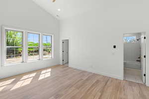 Spare room featuring light wood finished floors, vaulted ceiling, ceiling fan, and recessed lighting