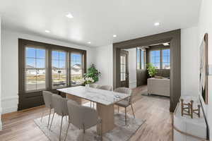 Dining room featuring light wood finished floors and recessed lighting