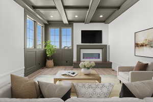 Living room featuring wood finished floors, recessed lighting, a glass covered fireplace, and coffered ceiling