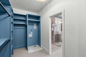 Walk in closet with light marble finish floors