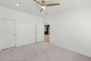 Unfurnished bedroom with light colored carpet, ceiling fan, and recessed lighting