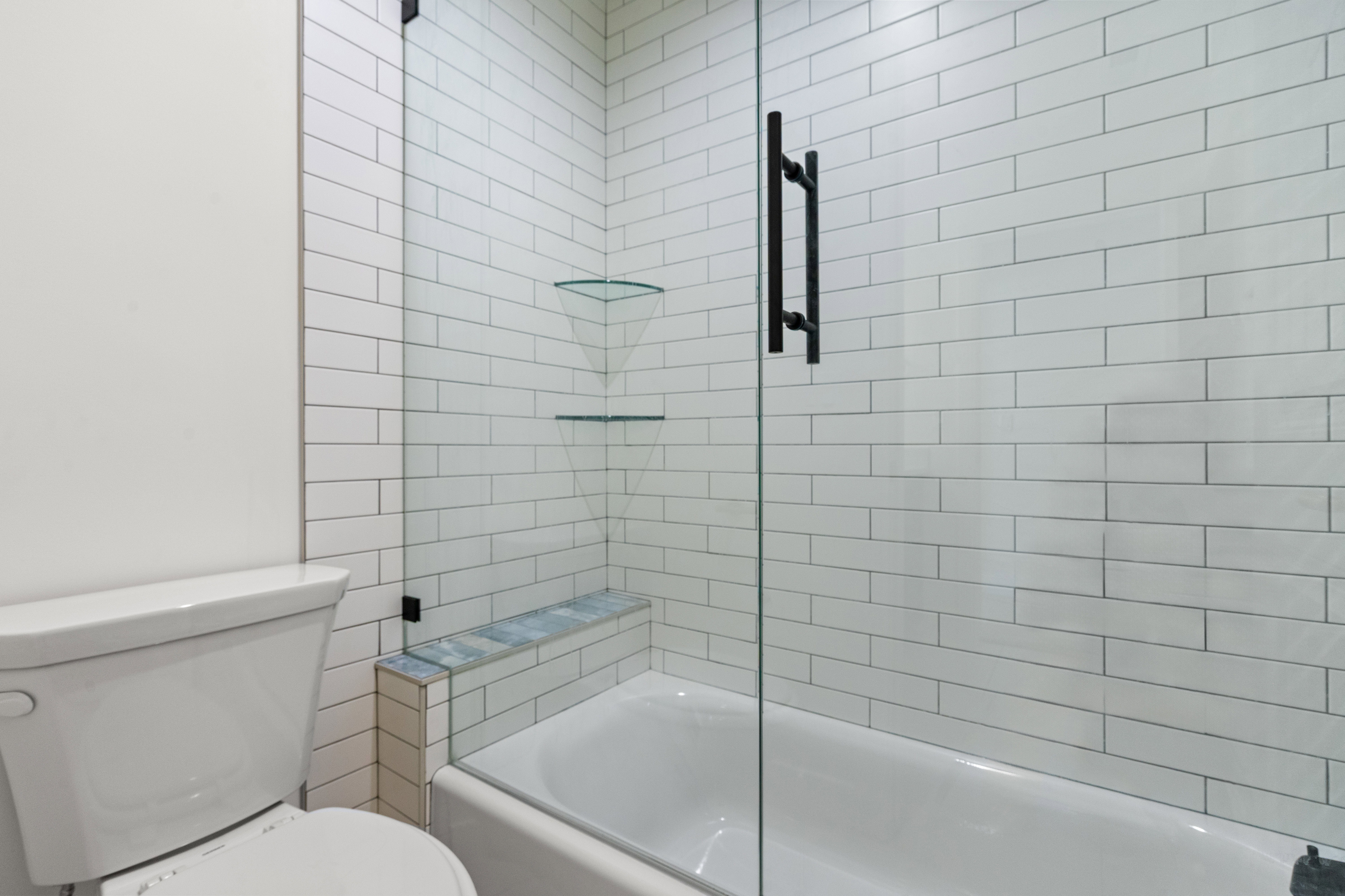 Bathroom featuring toilet and enclosed tub / shower combo
