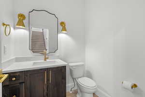 Half bathroom with vanity and light wood-style floors