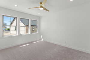 Empty room featuring carpet, ceiling fan, and recessed lighting