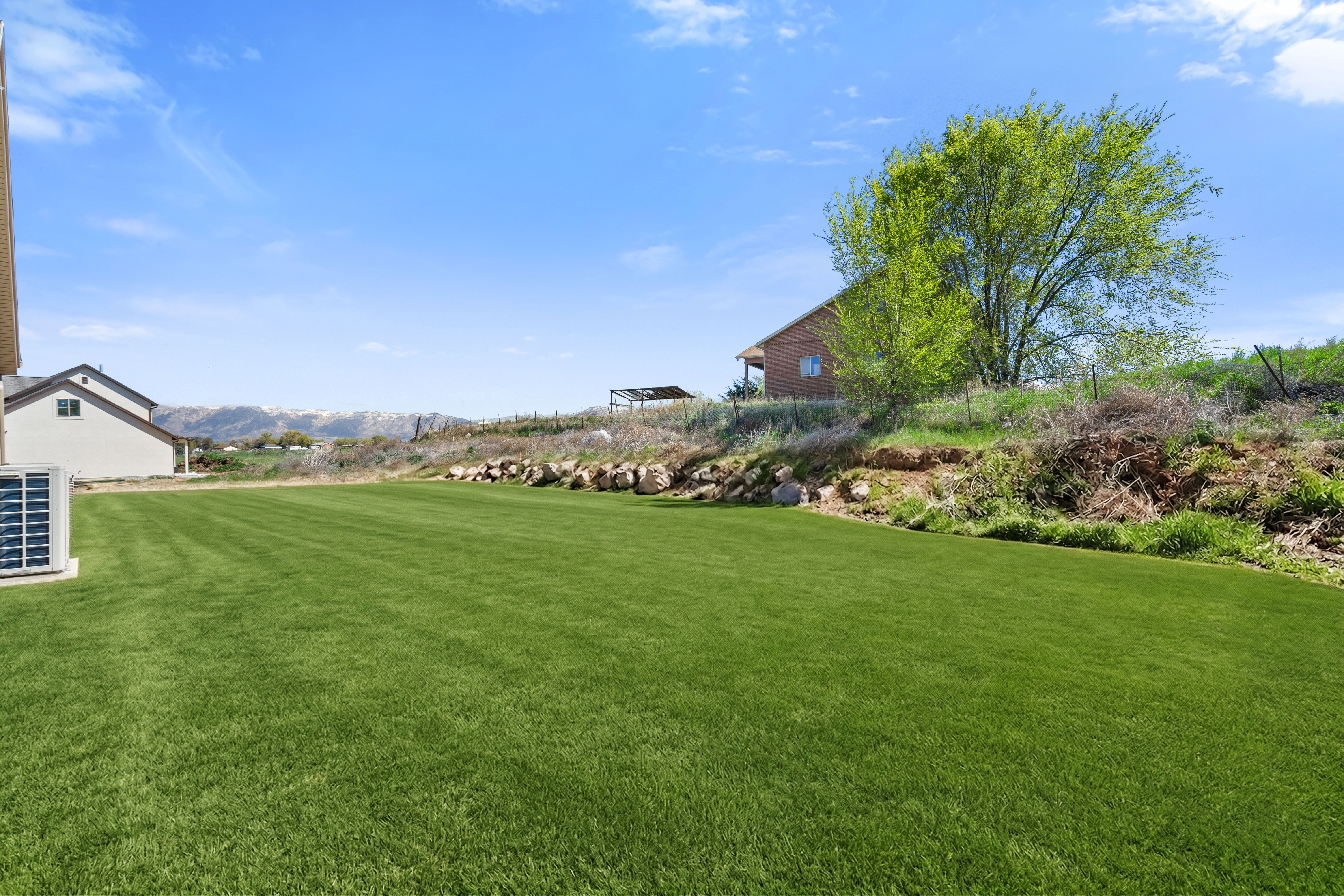 View of grassy yard featuring a mountain view