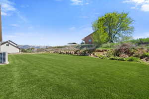 View of grassy yard featuring a mountain view