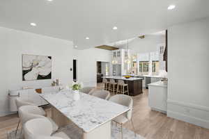 Dining room featuring light wood-style floors, recessed lighting, and lofted ceiling