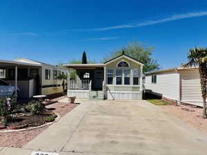Manufactured / mobile home featuring a porch and driveway