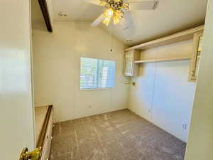 Unfurnished room featuring a ceiling fan and light colored carpet