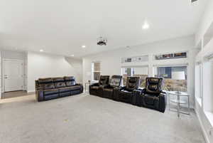 Home theater with light carpet and recessed lighting