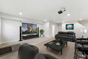 Virtually Staged Living area with carpet flooring and recessed lighting