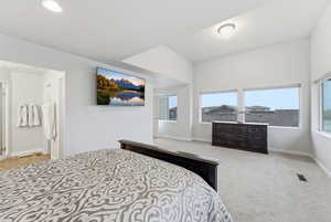 Bedroom with baseboards and light carpet