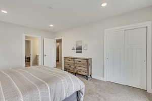 Bedroom featuring light carpet, a closet, and recessed lighting
