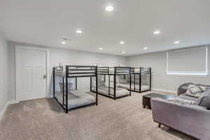 Bedroom featuring recessed lighting and light carpet