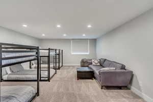 Living area featuring recessed lighting and light carpet