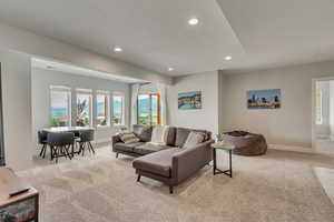 Living room with light carpet, recessed lighting, and a mountain view