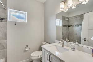 Full bathroom with vanity and tiled shower