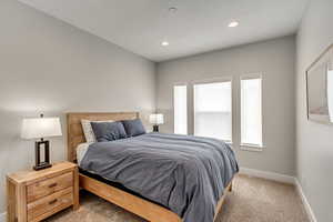 Bedroom featuring light carpet and recessed lighting