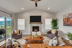 Living area with ceiling fan, a fireplace, recessed lighting, and wood finished floors