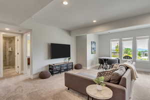Living room featuring recessed lighting and light carpet