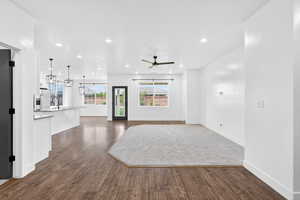 Unfurnished living room with dark wood-style floors, ceiling fan, and recessed lighting