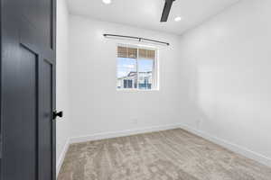 featuring light carpet, a ceiling fan, and recessed lighting,