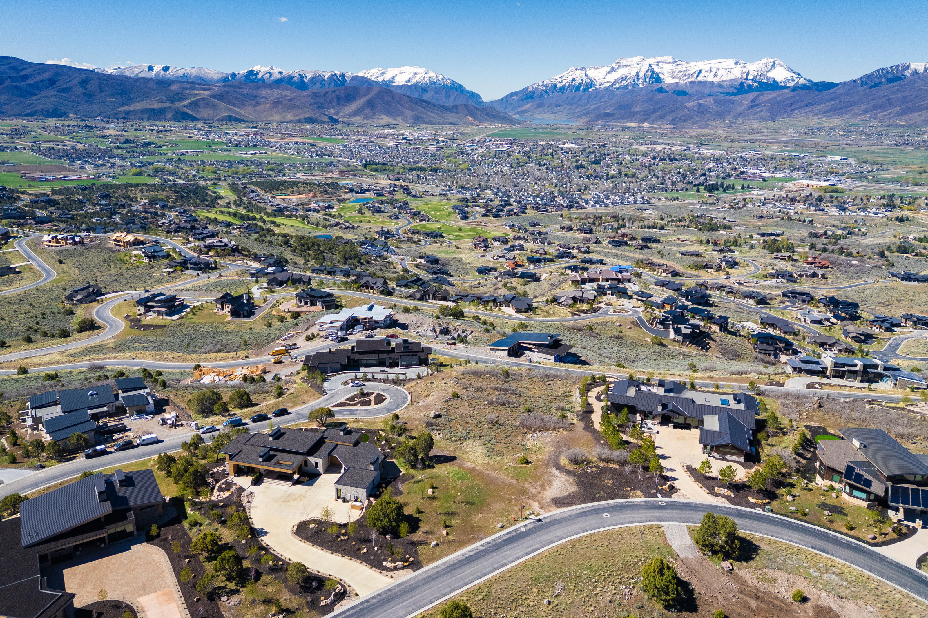 Aerial view of property's location with a mountain backdrop and nearby suburban area