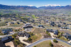Aerial view of property's location with a mountain backdrop and nearby suburban area