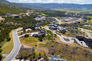 Aerial overview of property's location featuring a mountainous background