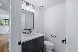 Half bath featuring vanity and light wood-type flooring