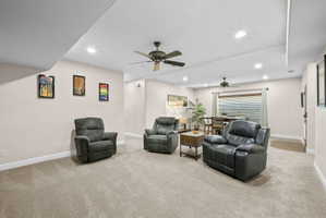 Living room featuring light carpet, recessed lighting, and a ceiling fan