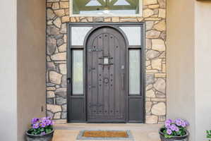 View of exterior entry featuring stone siding