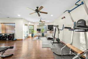 Workout room with a ceiling fan, recessed lighting, and wood finished floors
