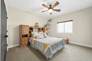 Bedroom featuring light colored carpet and ceiling fan