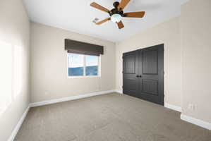 Unfurnished bedroom with light carpet, a closet, and ceiling fan