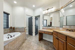 Full bathroom with vanity, a garden tub, recessed lighting, and light tile patterned flooring