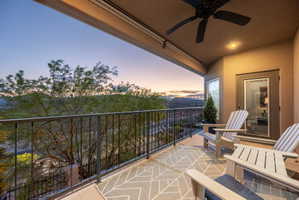 Balcony at dusk featuring ceiling fan