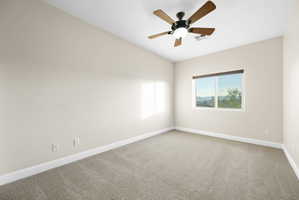 Empty room with light carpet and a ceiling fan