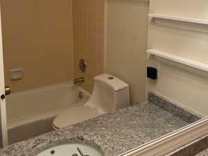 Bathroom with vanity and tub / shower combination