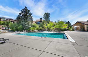 Community pool with a patio